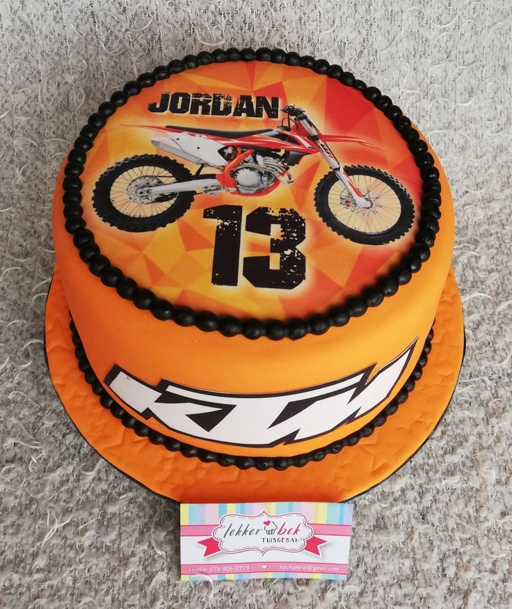 a birthday cake with an image of a motorbike on the front and number thirteen on the back