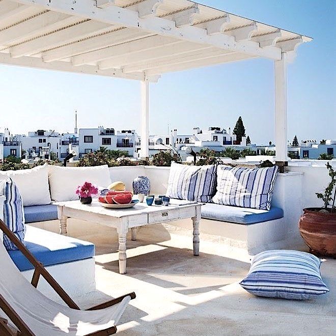 an outdoor living area with blue and white furniture