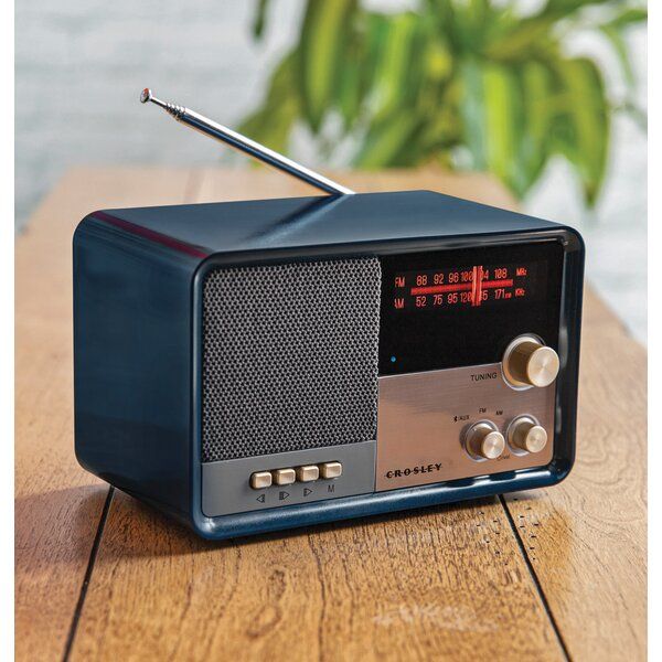 an old fashioned radio sitting on top of a wooden table