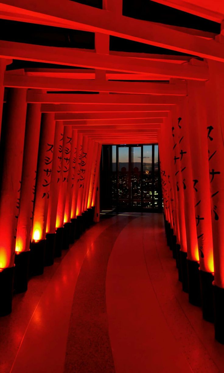 the inside of a building with red lights