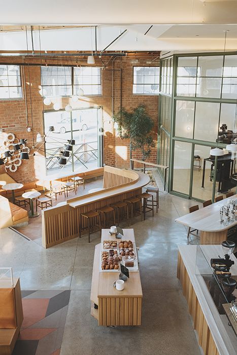 an overhead view of a coffee shop with lots of tables and benches in the center