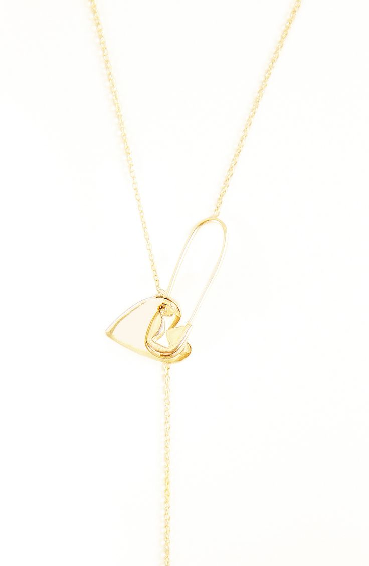 A diamond-accented heart twinkles at the bottom of a gleaming lariat necklace complete with trendy safety-pin hardware. 32" length. Safety-pin closure. Total diamond weight: 0.01ct. Sterling silver or sterling silver with 14k-gold plate/diamond. Imported. Adornia donates 10% of net profit to charities focused on female empowerment. Diamond Guide Gold Sterling Silver Lariat Chain Necklace, Gold Lariat Necklace For Everyday, Dainty Heart Charm Lariat Jewelry, Gold Link Lariat Necklace For Gifts, Yellow Gold Lariat Necklace In Brass As A Gift, Brass Lariat Necklace With Adjustable Chain As Gift, Adjustable Gold Lariat Necklace In Sterling Silver, Yellow Gold Brass Lariat Necklace As Gift, Gold-tone Chain Lariat Necklace Ideal As A Gift