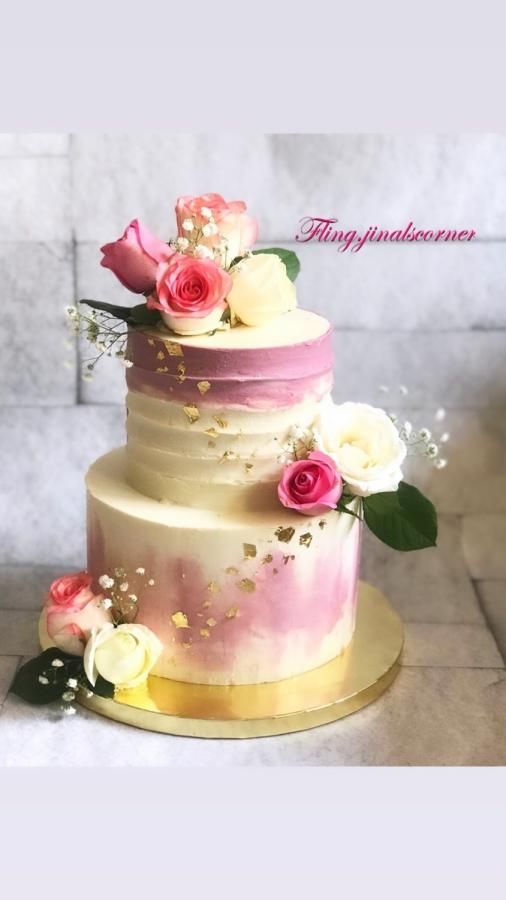 there is a three layer cake with flowers on it