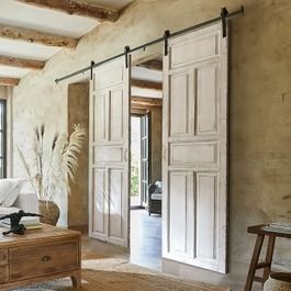 an open living room with sliding doors on the wall