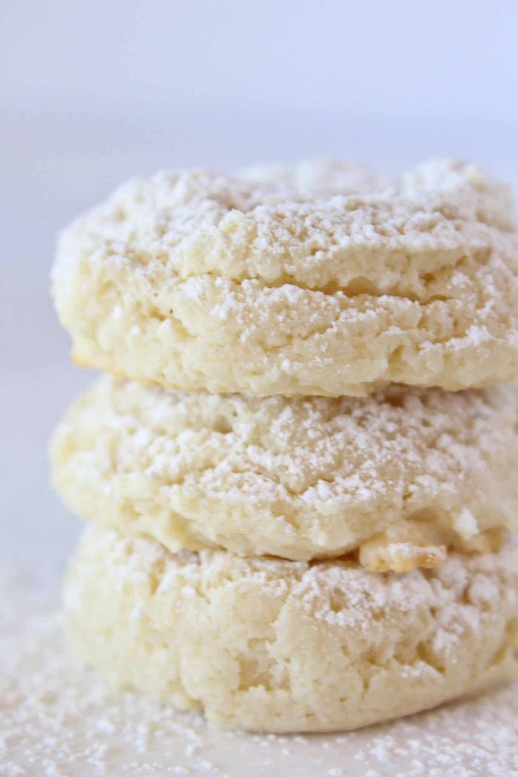 three powdered sugar cookies stacked on top of each other