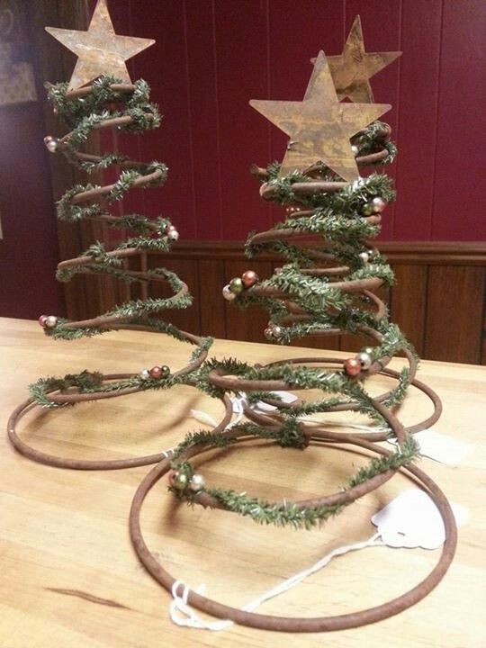 three small christmas trees sitting on top of a table