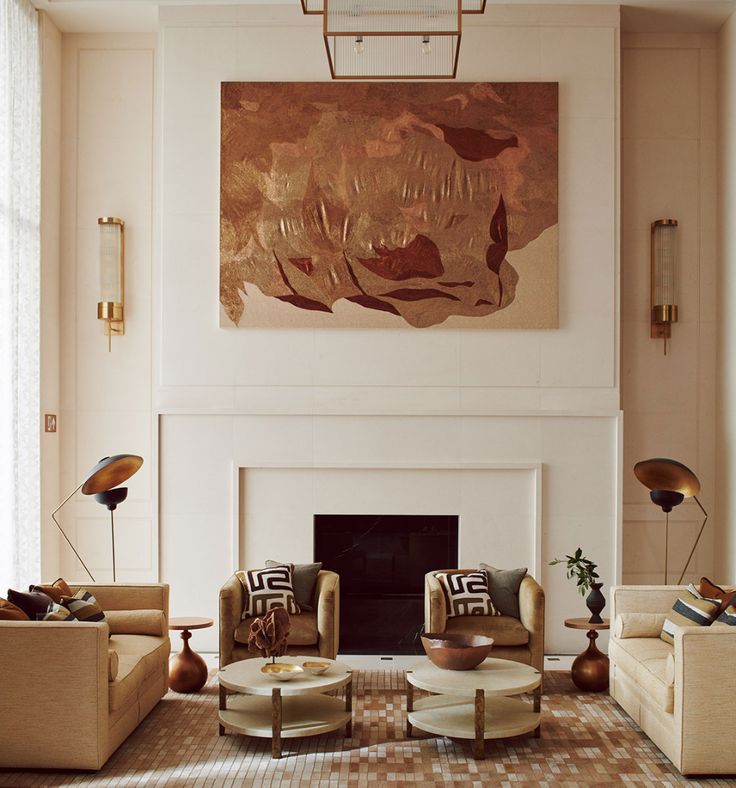 a living room filled with furniture and a painting on the wall above it's fireplace