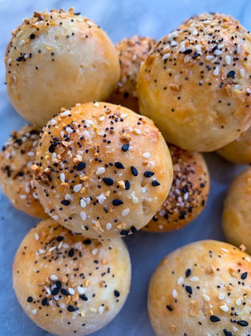 sesame seed buns are piled on top of each other