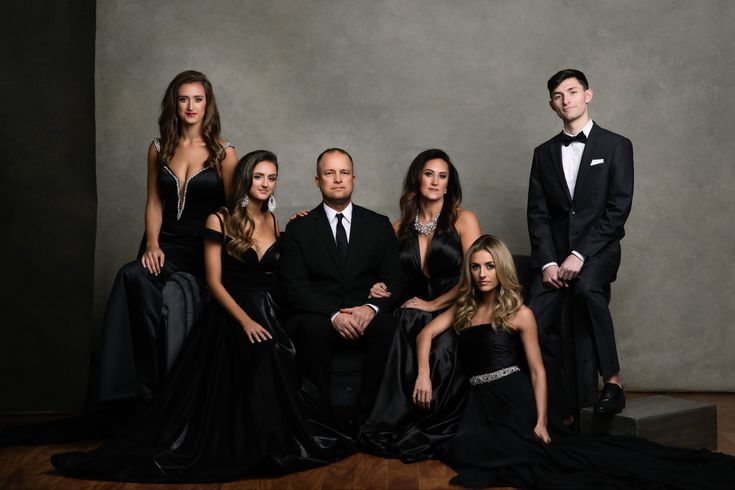 a group of people in formal wear posing for a photo