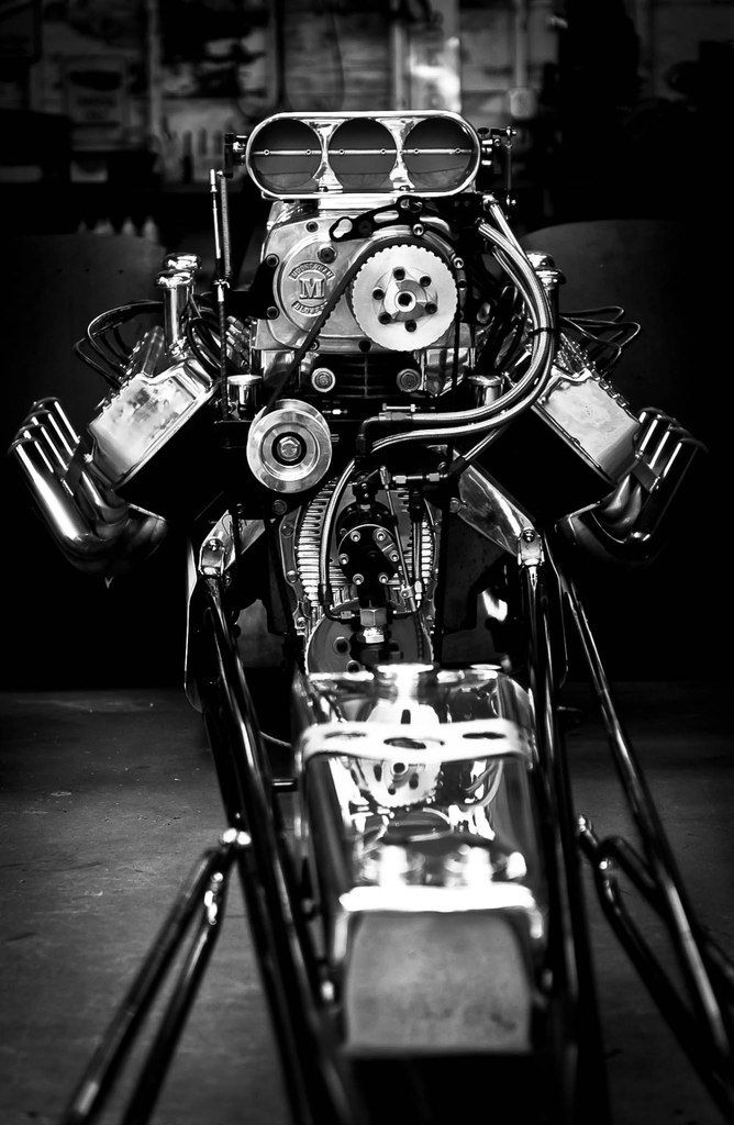 a motorcycle engine is shown in this black and white photo with glasses on it's head