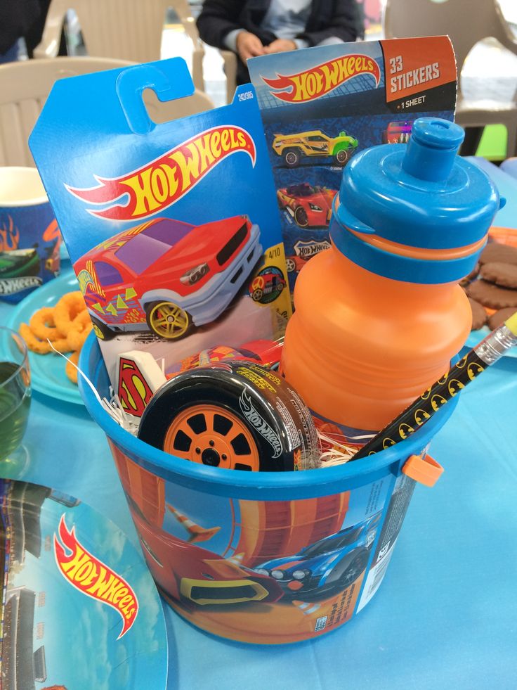 a blue table topped with a plastic cup filled with toys