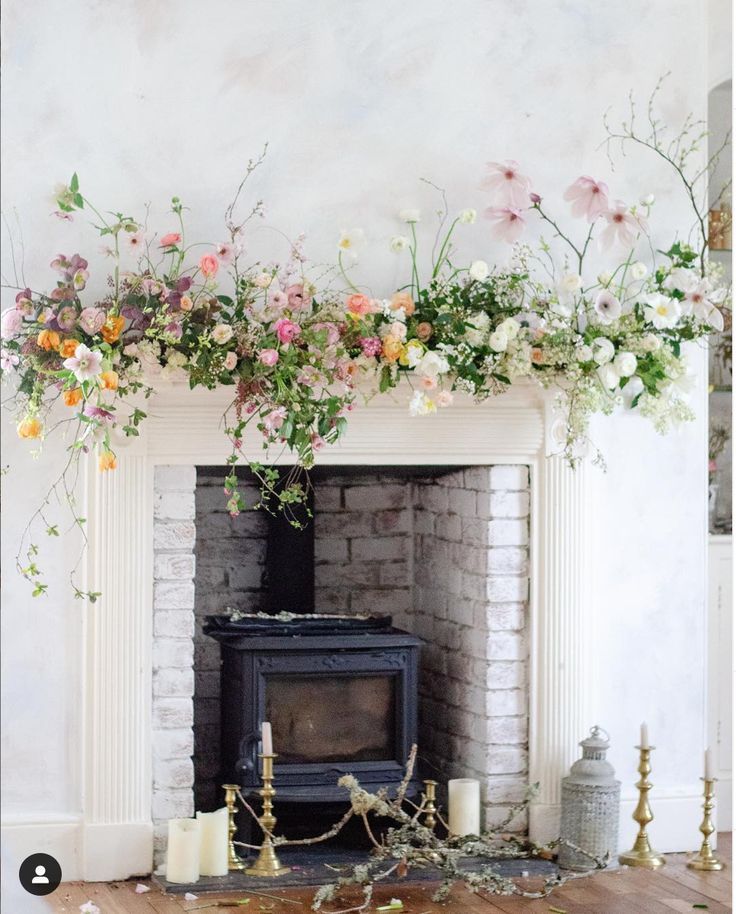 a fireplace decorated with flowers and candles