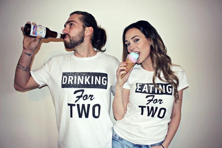 two people wearing matching t - shirts eating for two drinking beer and eating ice cream