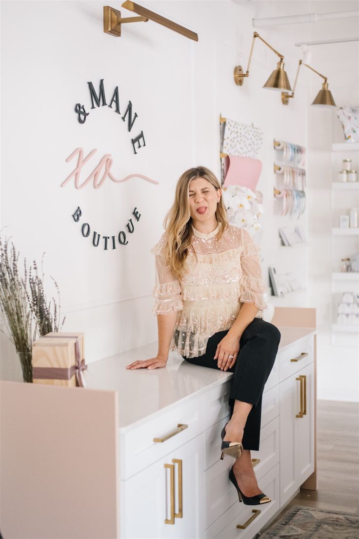 a woman sitting on top of a counter