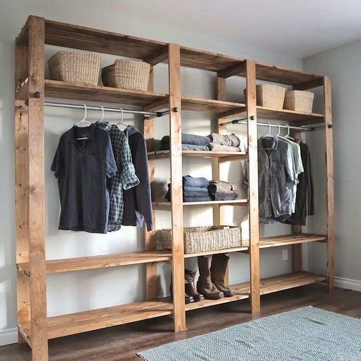 a wooden shelf with clothes hanging on it