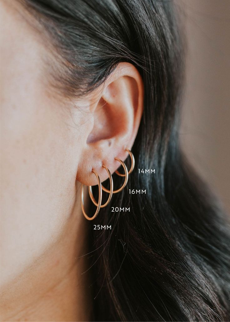 We love the simplicity of these subtle hoops. These work as great second or third piercing staples, but these classic hoops can hold down the fort all on their own! Sold as a pair in 12mm, 14mm, 16mm, 20mm, and 25mm. Endless Hoop How-To: To open the hoop, gently pull the wire post out of the tube. Shift the two ends of the hoop sideways (apart from each other) to fit around your lobe. Then, insert the thinner wire into the front side of your piercing. Once it’s in, gently pull apart to get the w