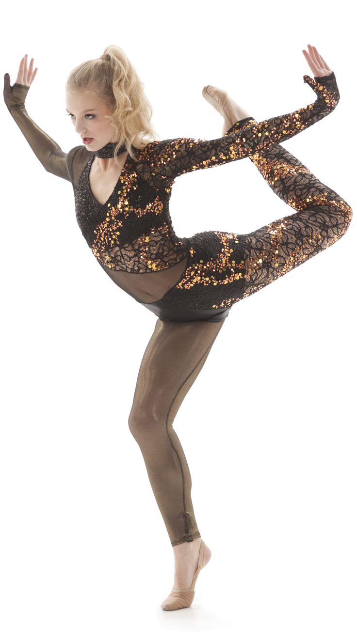 a woman in black leotard and gold sequins is posing for the camera