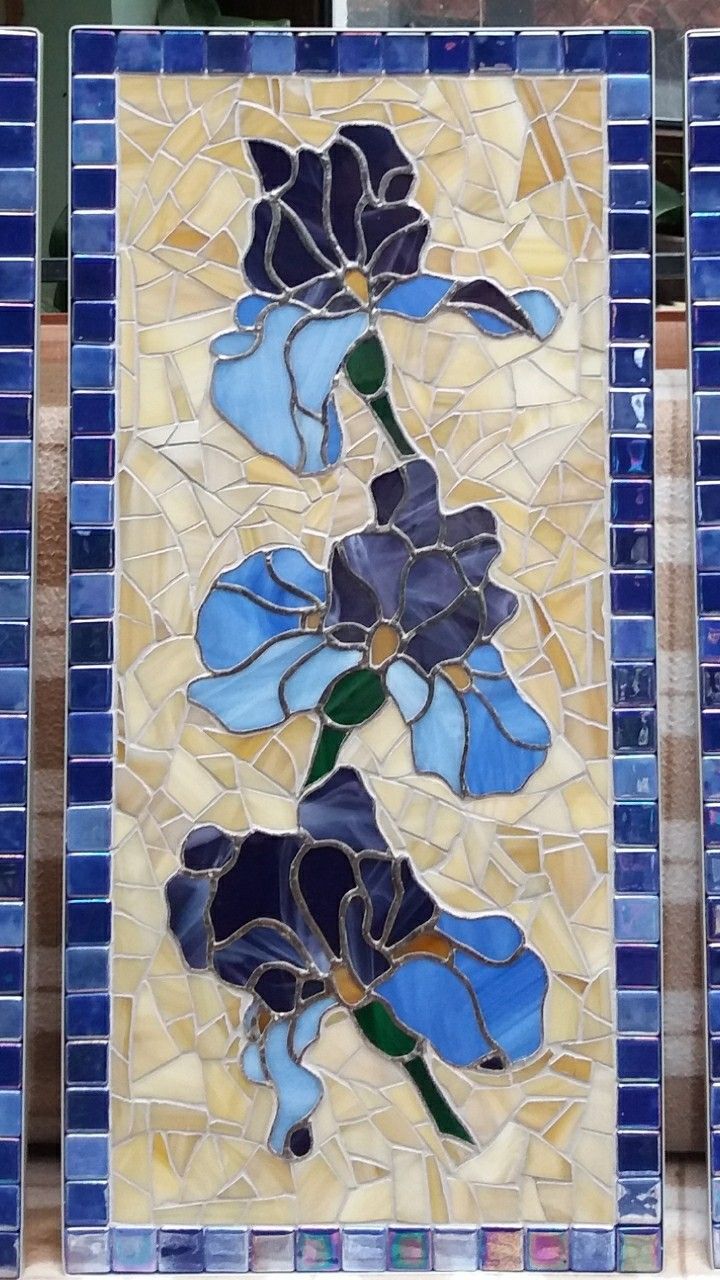 two blue and yellow tiles with flowers on them