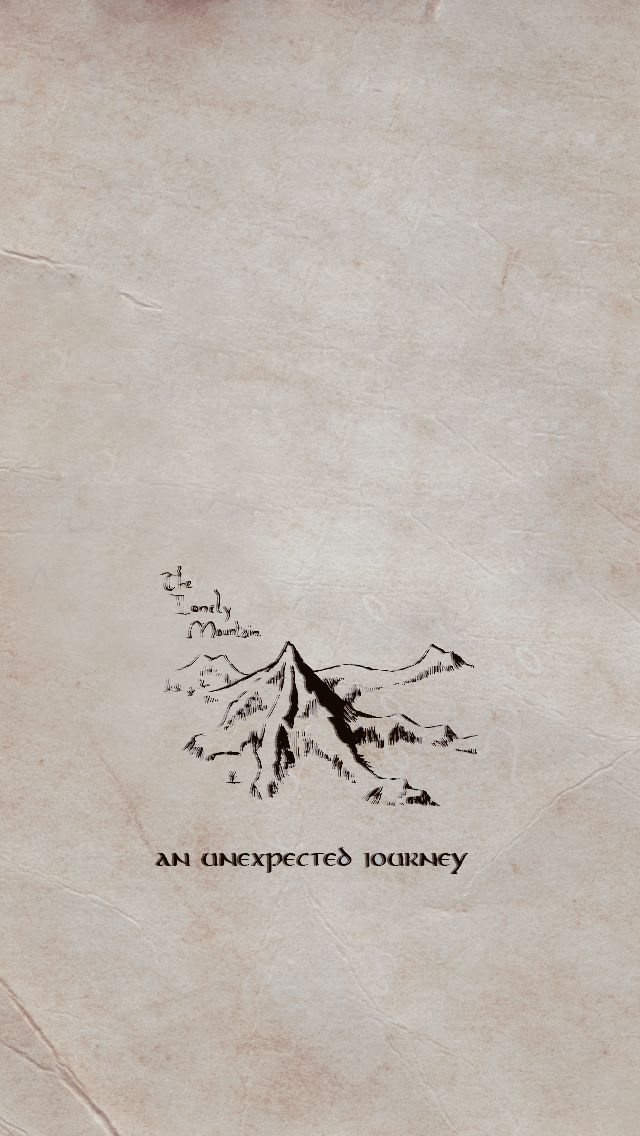 an old book with writing on it that says an unexpected journey and mountains in the background