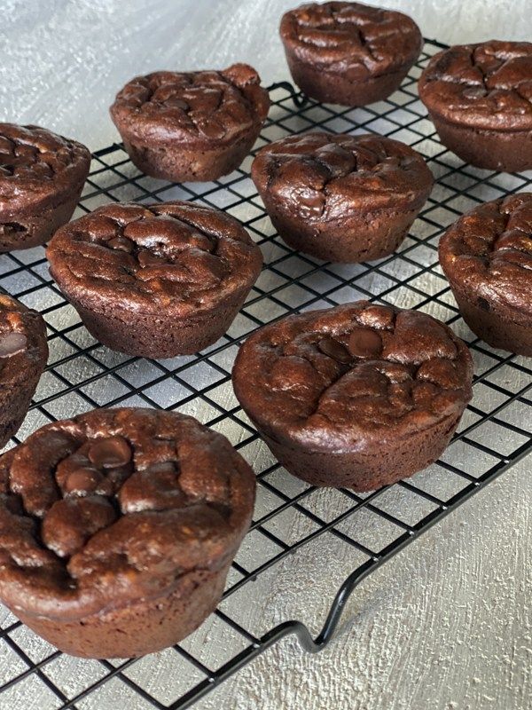 chocolate muffins cooling on a wire rack, ready to be baked in the oven