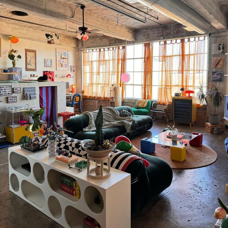 a living room filled with furniture and lots of windows