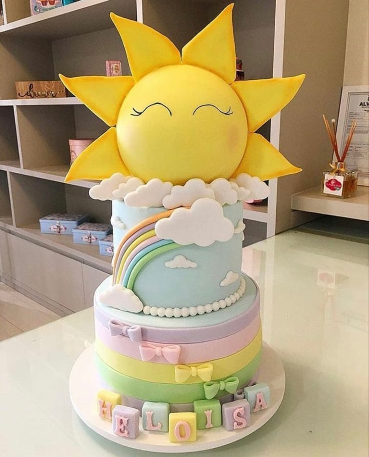 a cake that is sitting on top of a table with the sun in the middle