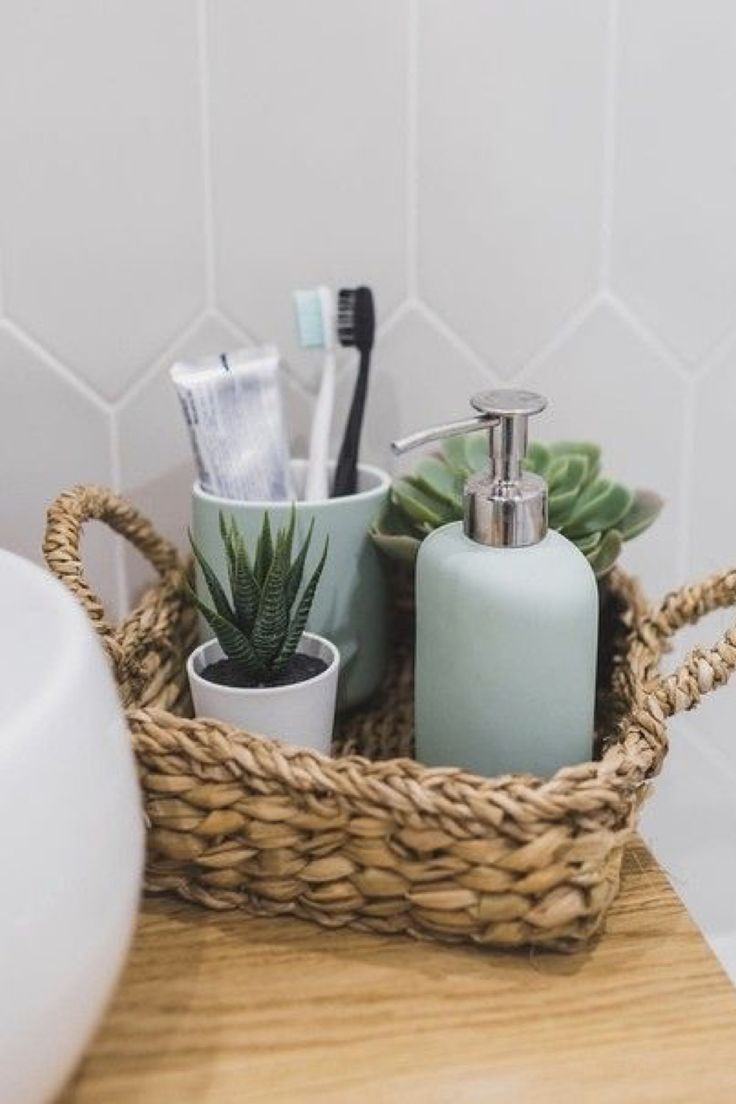 a basket with toothbrushes, soap and other items in it on a counter