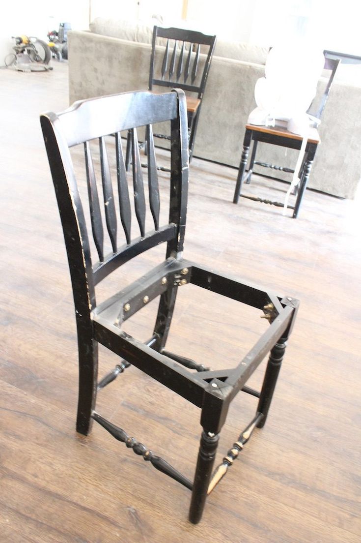 two chairs sitting on top of a wooden floor next to each other in a room