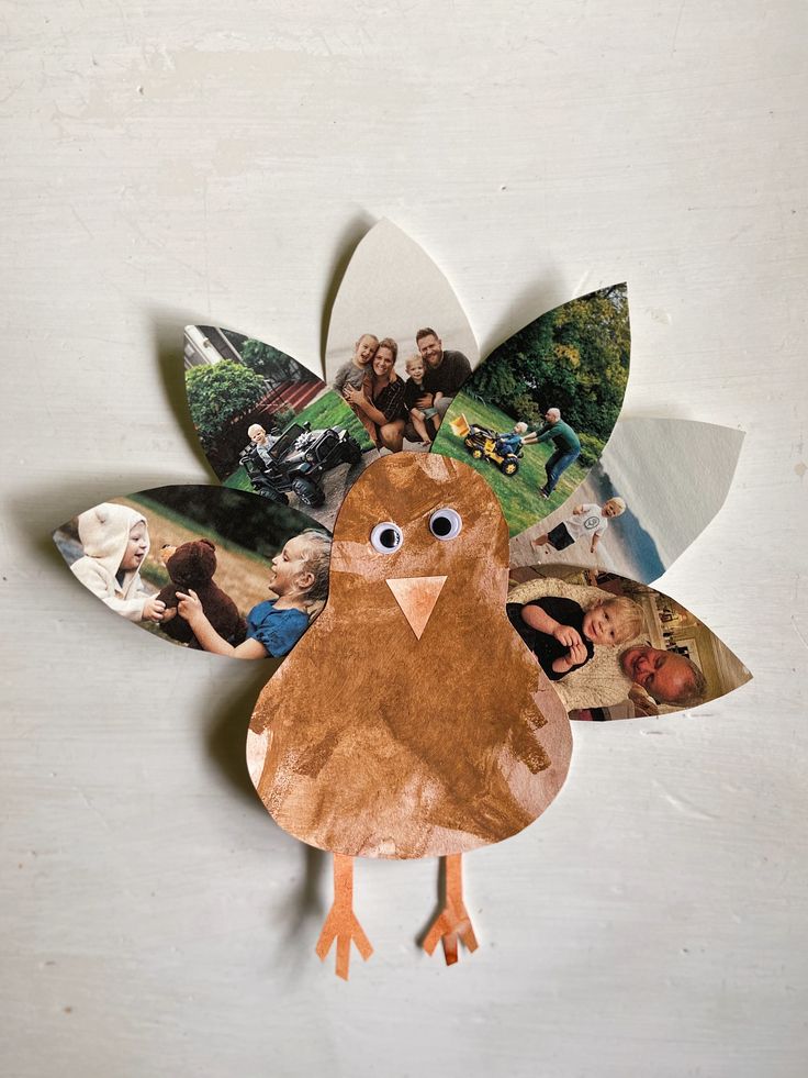 a turkey made out of paper with photos on it's back and leaves attached to the side