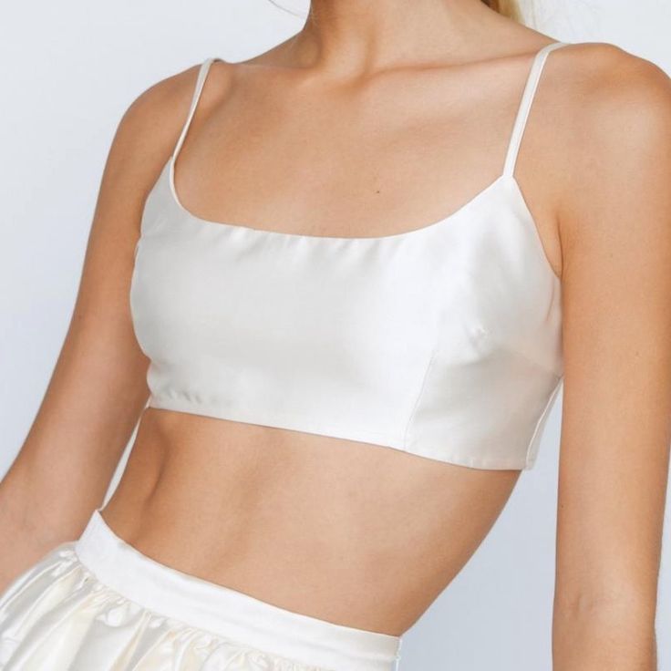 Ivory Premium Satin Spaghetti Strap Scoop Neck Micro Crop Top With Back Zip Closure New/Never Worn - Sold Out On Nastygal Cream Camisole With Built-in Bra And Spaghetti Straps, Elegant Sleeveless Cream Crop Top, Summer Wedding Tops With Delicate Straps, Elegant White Crop Top With Adjustable Straps, Elegant White Crop Top With Straps, White Satin Tank Top For Summer, Elegant Cami Crop Top With Delicate Straps, White Camisole Crop Top With Delicate Straps, White Satin Camisole For Spring