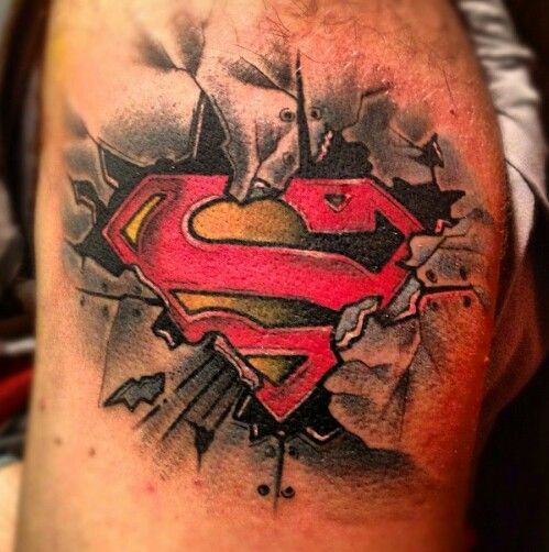 a man with a superman tattoo on his arm