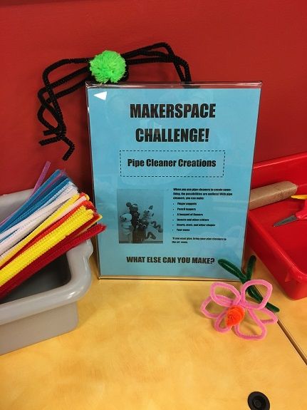 there is a sign that says makerspace challenge and some scissors on the table