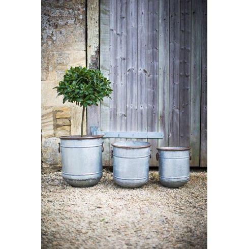 three metal planters sitting next to each other