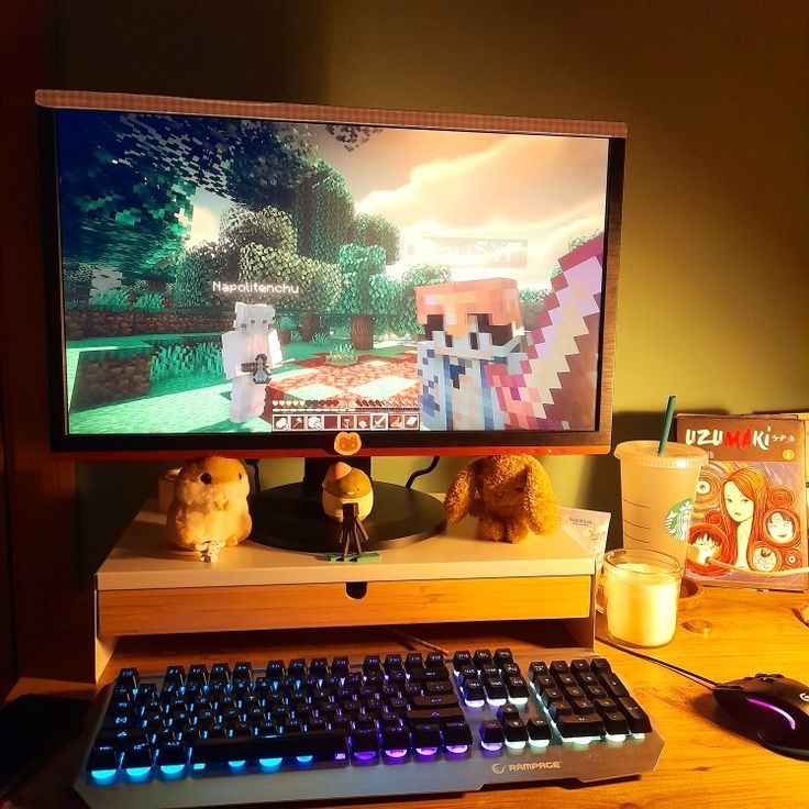 two stuffed animals are sitting in front of a computer monitor with the game minecraft on it