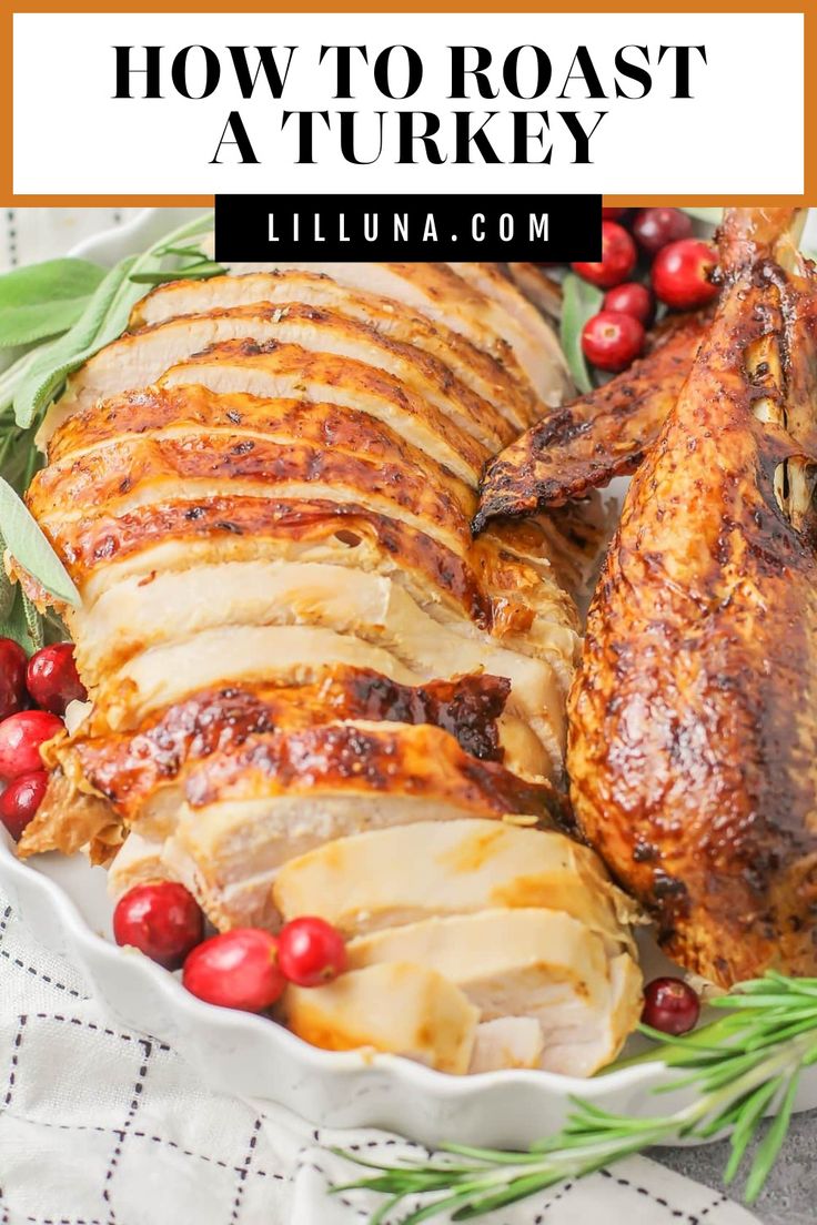 roasted turkey with cranberries and rosemary garnish in a white serving dish