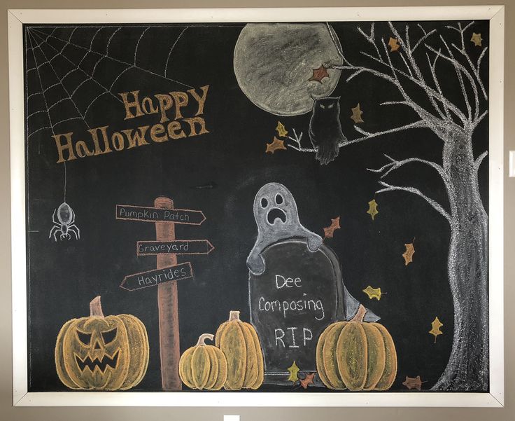 a chalk board with halloween decorations on it