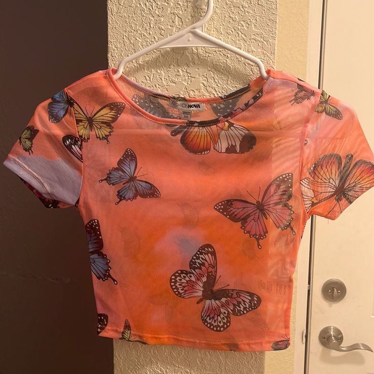 Fashion Nova Crop Top. Mesh See Thru. Size Xs (True To Size) No Tags But Never Worn And In 100% Perfect Condition. Open To Offers Printed Short Sleeve Crop Top, Fitted Summer Top With Butterfly Print, Fitted Butterfly Print Top For Summer, Orange Short Sleeve Crop Top For Summer, Multicolor Graphic Print Crop Top, Trendy Orange Short Sleeve Crop Top, Multicolor Butterfly Print Top For Summer, Multicolor Butterfly Print Tops For Summer, Fitted Short Sleeve Top With Butterfly Print