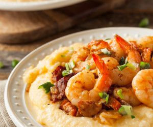 shrimp and grits on top of mashed potatoes