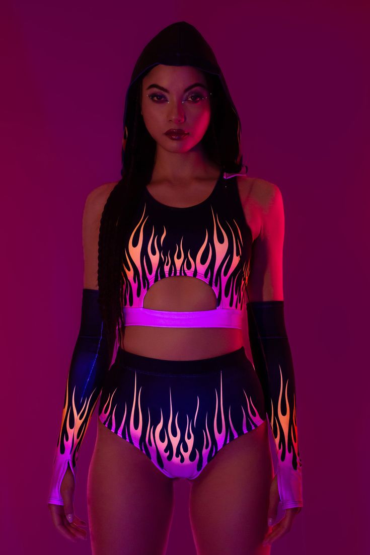 Flames flicker with your every move as the ultraviolet lights embrace you, leaving a trail of light in the darkness of night. The design features a sleeveless construction with a provocative cutout exposing the skin. A detachable hood provides an dash of mystery and and a lot of versatility. Take it off or put it on, just make sure to pair with the matching high waist shorts and gloves. FEATURES: > Detachable Oversized Hood  > Underbust Cutout  > Flattering Form-Fitting Construction  > Non–Transparent Lycra Fabric Wrestling Attire, Pole Clothes, Romper Men, Wwe Outfits, Rave Babe, Wrestling Gear, Light In The Darkness, Festival Outfits Rave, Look Festival