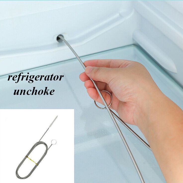 a hand holding a pair of scissors in front of a refrigerator door with the words refrigerator unchoke above it