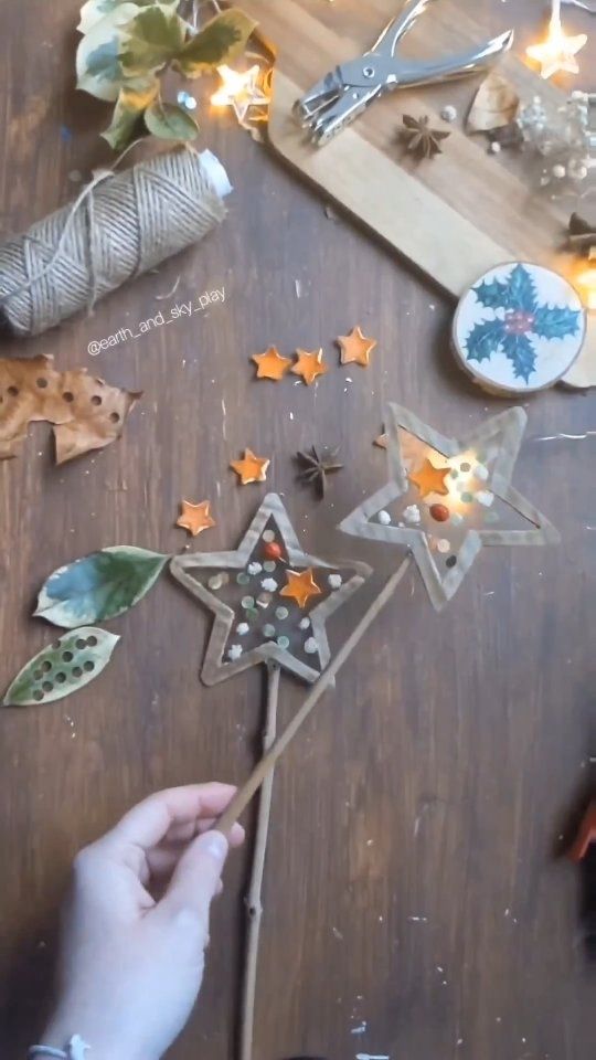 someone is decorating a wooden star with leaves and other things to decorate it on the table