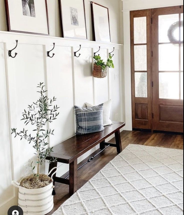 a wooden bench sitting next to a white rug