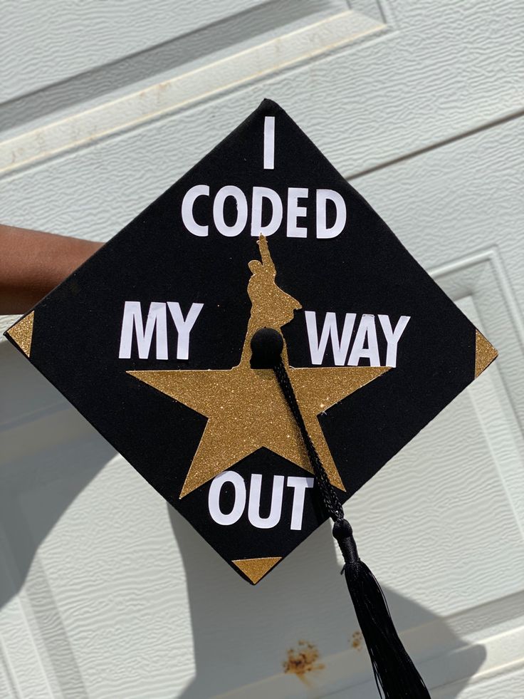 a black and gold graduation cap that says i coded my way out