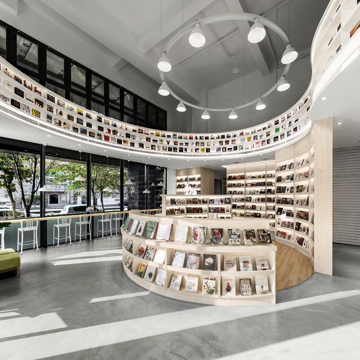 the inside of a book store with many books on shelves and pictures hanging from the ceiling