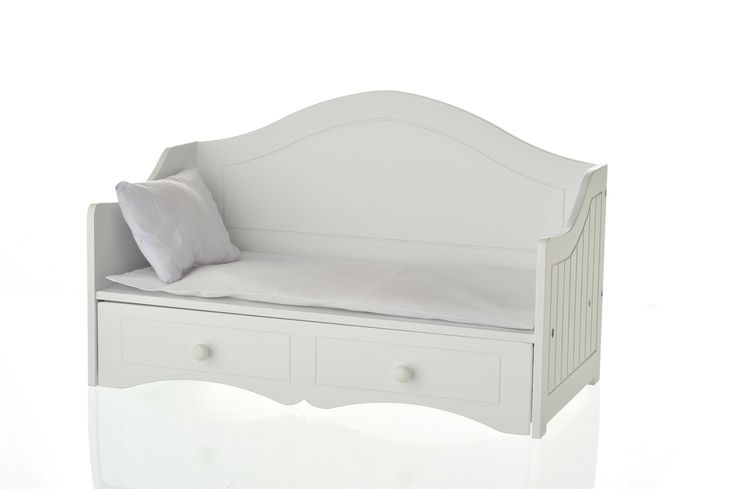 a white daybed with drawers underneath it and a pillow on the bottom shelf next to it