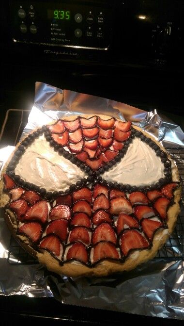 there is a pie with strawberries on it sitting on the oven rack, ready to be baked