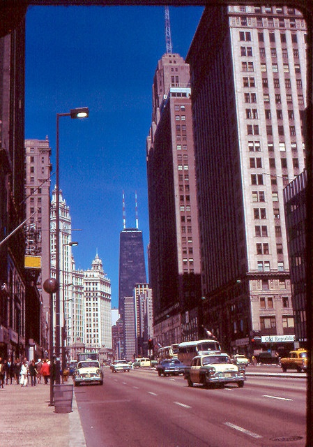 the city street is lined with tall buildings