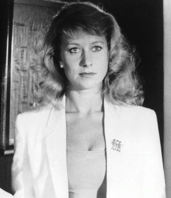 an old photo of a woman in a white blazer and bra - revealing cleavage