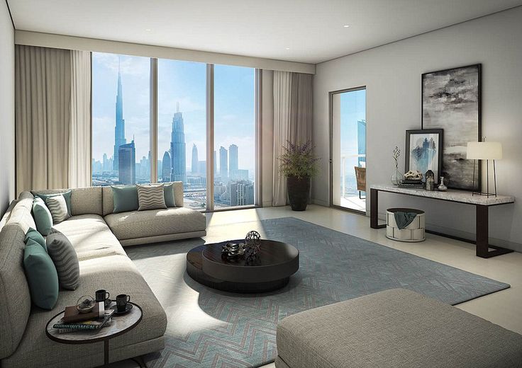 a living room filled with lots of furniture and tall buildings in the backround