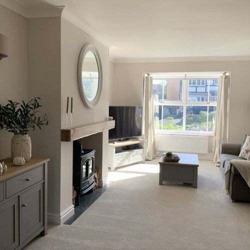 a living room filled with furniture and a fire place